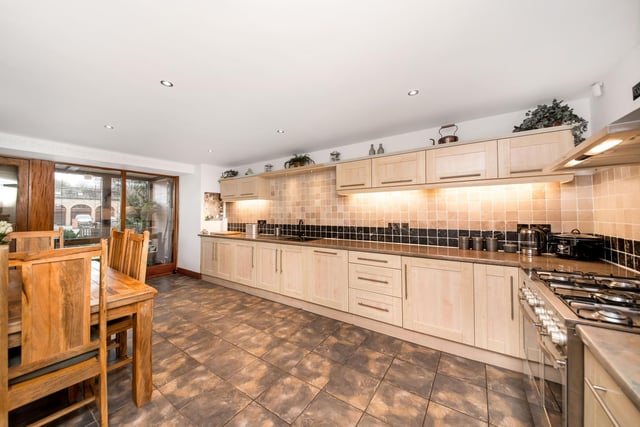The large dining kitchen has fitted Shaker style units with a range of integrated appliances.