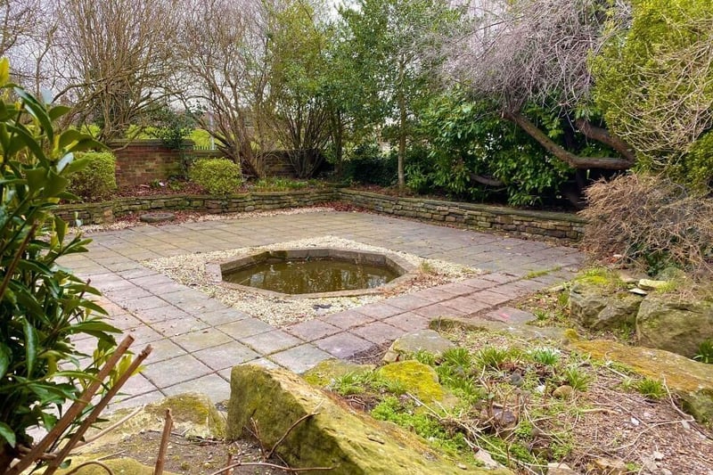 The walled patio garden with feature pond.