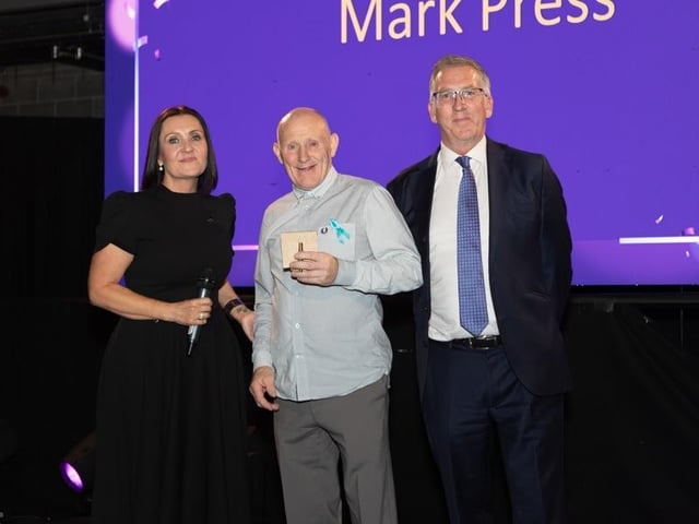 Prince of Wales supporter Mark Press picking up an award.