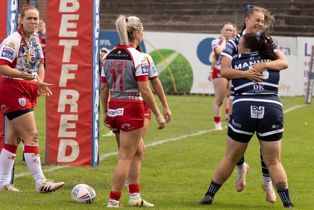 Charley Blackburn celebrates scoring the opening try for Featherstone Rovers Women against Leigh Leopards.