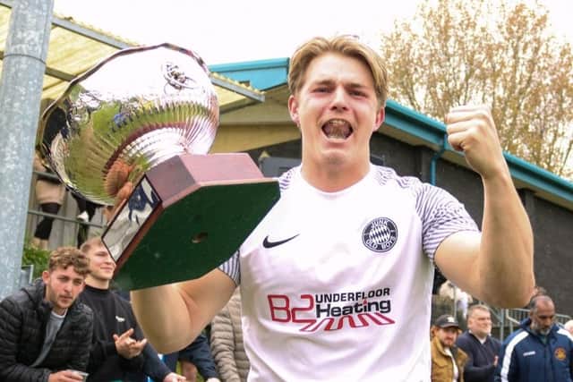 Man of the match, Junk Old Boys midfielder George Whittaker celebrating his award with the Landlords Trophy following his side's 5-3 penalty shootout success over Chequerfield FC. Pic: mm10_sports_photo