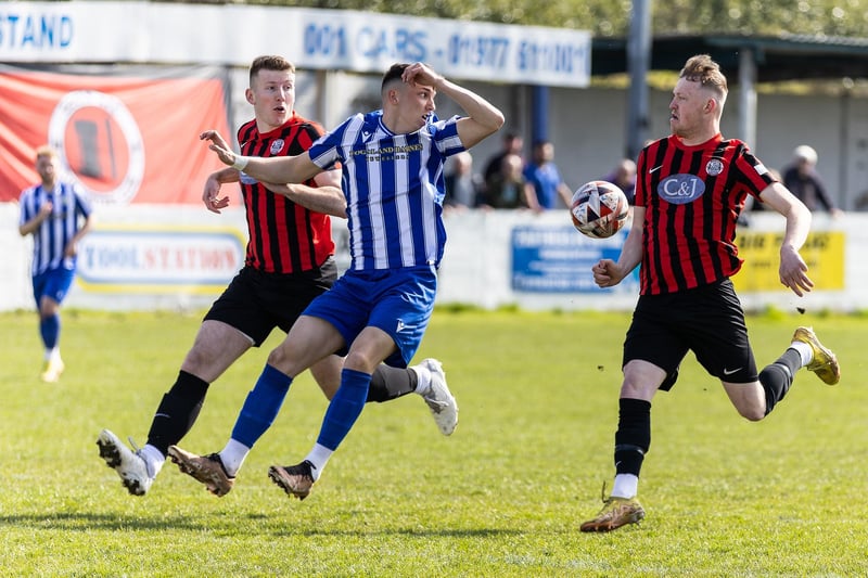 Frickley and Goole players have their eyes on the bouncing ball.
