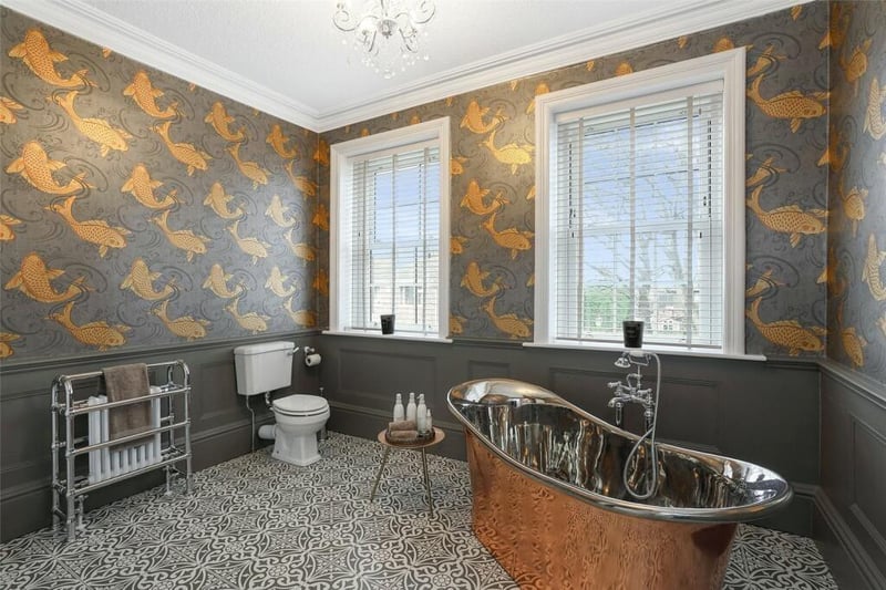 The stunning house bathroom has a feature copper free standing bath.
