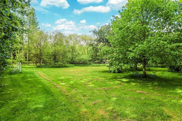 The plot of 1.63 acres includes lawned gardens and a paddock area.