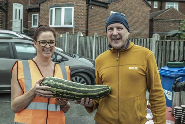 Francesca Lawrence with a member of the Comrades club and some produce donated from their allotment