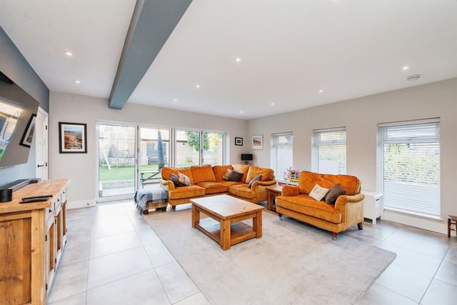 This bright and spacious room has quadruple folding doors to the gardens.