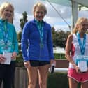 Christine McCarthy at the top of the podium after receiving her award as winner of the international marathon against the Celtic nations in the Women's Over 60 age group at Chester.