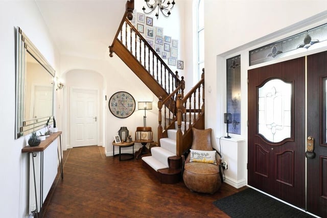 Within the hallway, is the mahogany feature open staircase with a gallaried landing.