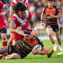 Castleford Tigers' George Griffin is brought down by Tim Lafai in the 42-10 defeat to Salford Red Devils. Picture: Bruce Rollinson