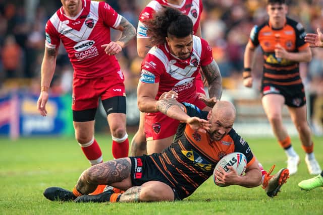 Castleford Tigers' George Griffin is brought down by Tim Lafai in the 42-10 defeat to Salford Red Devils. Picture: Bruce Rollinson