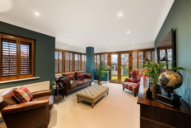 This light and spacious lounge has bespoke wooden plantation blinds to its many windows.