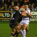 Wakefield Trinity's Sam Hewitt is stopped in his tracks by Castleford Tigers' former Wakefield player Paul McShane. Picture: Jonathan Gawthorpe