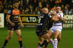 Wakefield Trinity's Sam Hewitt is stopped in his tracks by Castleford Tigers' former Wakefield player Paul McShane. Picture: Jonathan Gawthorpe