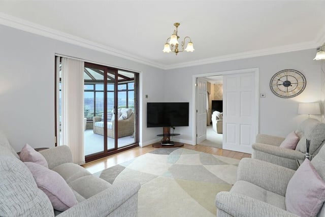 The room features oak flooring and double glazed patio doors that lead through to the conservatory.