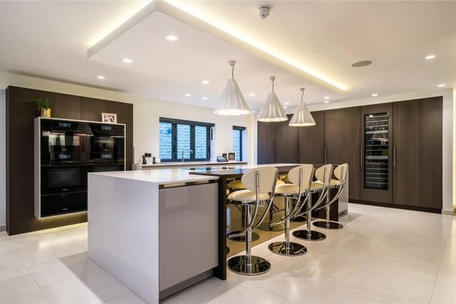 The kitchen has a four meter kitchen island, integrated Miele appliances including; full size wine cooler, integrated fridge freezer, two dishwashers, two ovens, and a microwave.