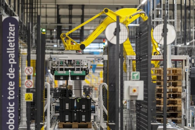 Amazon uses a robotic tote depalletizer as a safer, more consistent and quicker way of unloading totes of items from pallets.