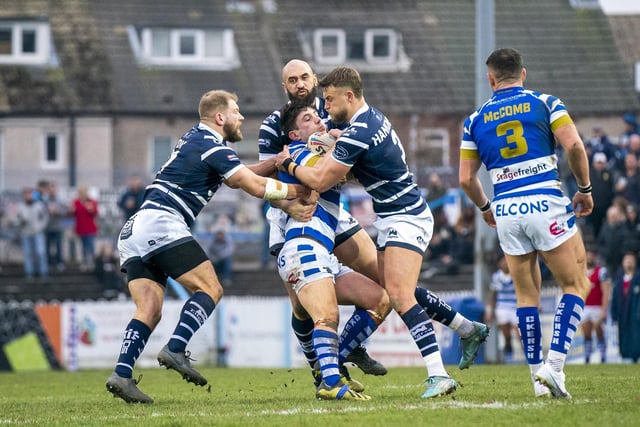 A Halifax Panthers player is all wrapped up by Featherstone Rovers tacklers Chris Hankinson, Brad Day and Johnathan Ford.