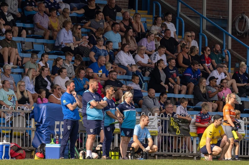Featherstone Rovers' coaching staff and spectators watch on.