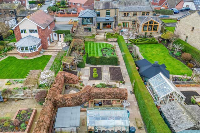 An overview of the property with its varied and expansive rear garden.