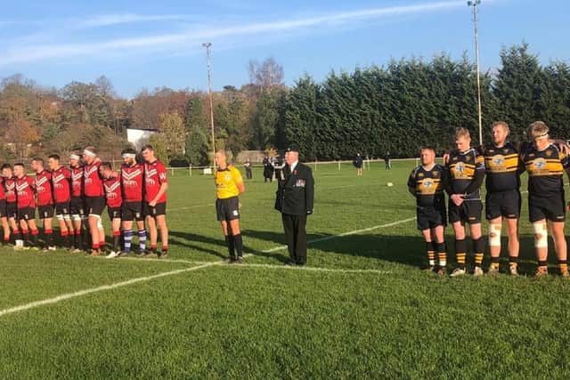 Pontefract RUFC and Bridlington players stand as the Last Post is played on the bugle by ex-forces veteran Kev Fawcett before the game last Saturday.