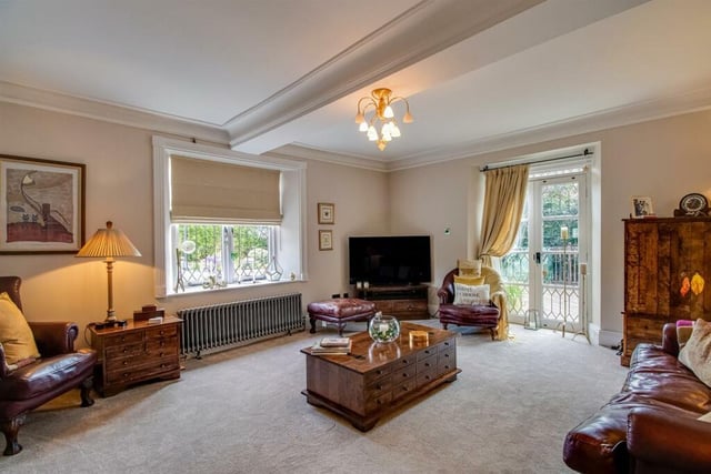 The principal living room is of fine proportions, overlooking the garden and having a feature fireplace.