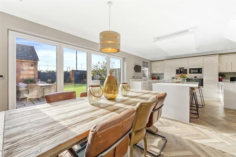 The kitchen seamlessly flows into the dining area, which can more than comfortably accommodate a large dining table, making it ideal for hosting dinner parties.