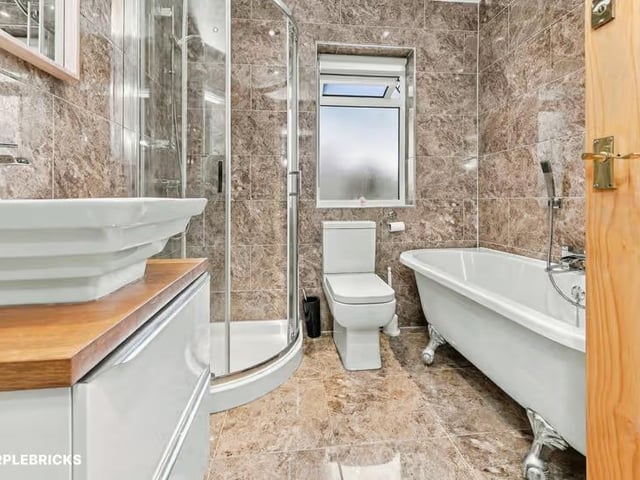 The family bathroom features a free-standing bath and a shower.