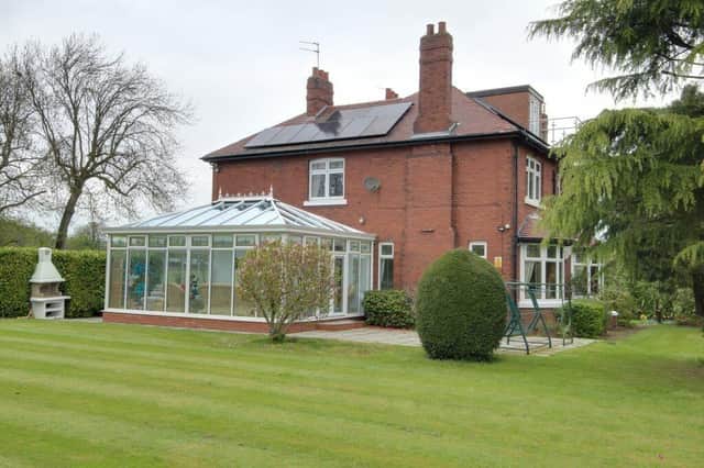 View across the garden to the house, with its large conservatory.