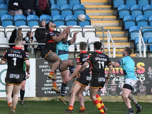 Featherstone Rovers and Dewsbury Rams players compete for a high ball in Sunday's friendly at the Millennium Stadium, which Rovers won 28-14. Picture: Rob Hare