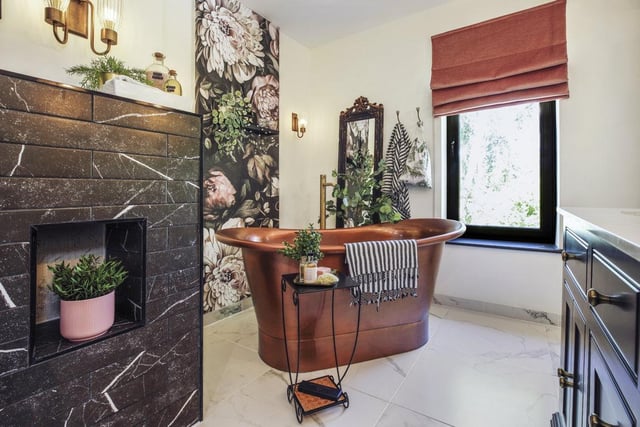 A deep copper bath is a showpiece within this luxurious bathroom.