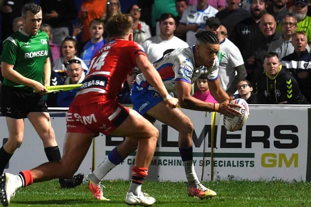 Lewis Murphy on the way to scoring Wakefield Trinity's second try in their win over Hull KR. Picture: Jonathan Gawthorpe
