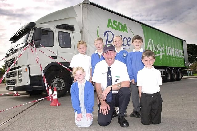 Road Safety day at Martin Frobisher Infants School with Asda Wakefield. Pictured with one of Asda Wakefield's trucks are (back L to R) Bradley Holbrook, Lauren Swift, Leah Watts, Joseph Isles with (front L to R) Georgina Gayles, Doug Hipkiss - Driver Trainer for Asda Wakefield and Michael Hill. Taken in 2004.