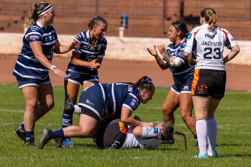 Shanelle Mannion makes a crunching tackle.