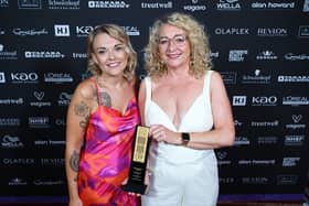 Owner of En Route Hair and Beauty, Melenie Tudor, and salon manager, Shannon Giblin,, receiving the trophy at British Hairdressing Business Awards.