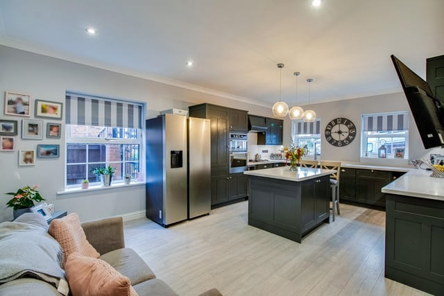 A modern, open plan kitchen with family area.