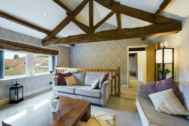 The original beams within the upstairs lounge are lovingly preserved and add character and charm to the space.