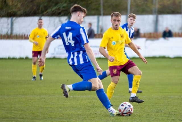 Joe Clegg looks to play the ball forward for Frickley Athletic.