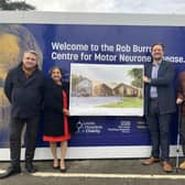 An MND patient, staff, charity representative and architects with plans for the centre