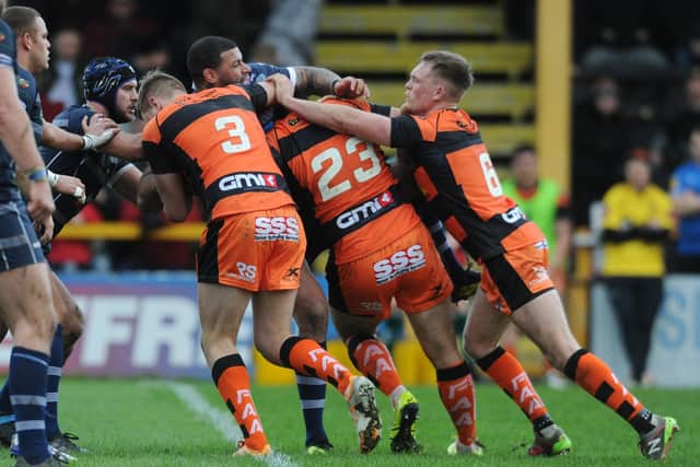 Action from Castleford Tigers' last meeting with neighbours Featherstone Rovers sees Ryan Bailey stopped by three tacklers.