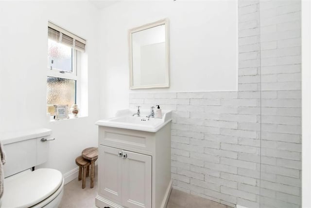 The en suite is fitted with a delightful stylish suite in white comprising of a wash hand basin/vanity unit with storage cupboards underneath, a low level W.C, a large fixed glazed screen shower with high quality fittings and an attractive ceramic tiled floor.