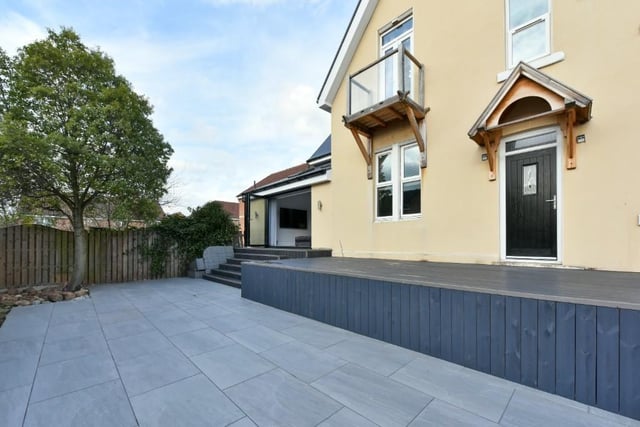 To the rear of the property is a raised composite decking area leading town to a porcelain tiled area with mature shrubbery.