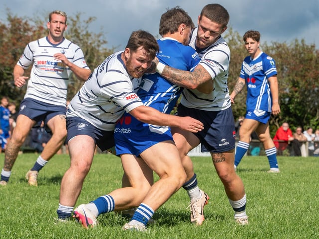Jamie Deal and Alfie Beresford get to grips with the Barrow Island full-back.