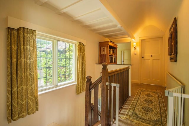 The upstairs landing has two built in storage cupboards, a single panel radiator and a leaded window.