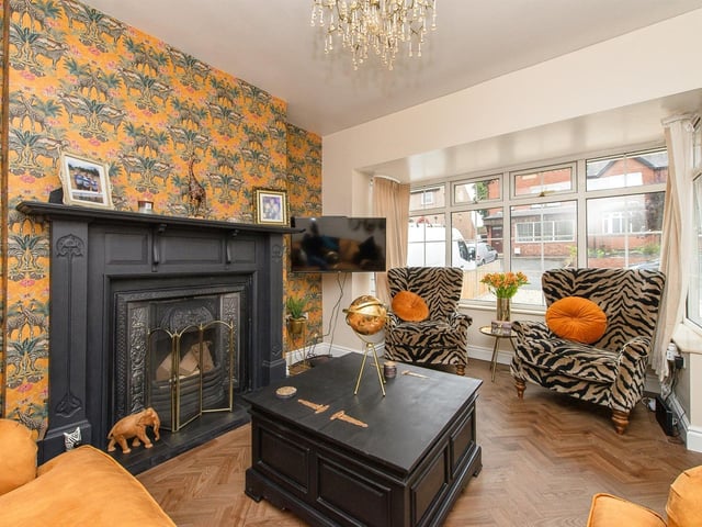 A wide bay window gives extra seating space in this reception room.