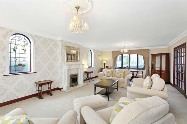 The living room includes two double glazed windows to both front and rear, coving to the ceiling, two wall light points and a feature fire surround and hearth.