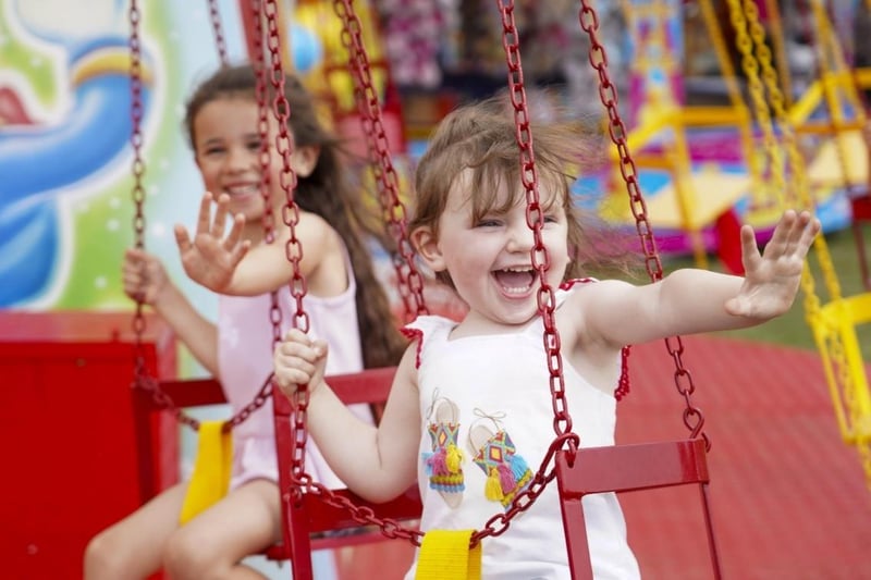 Children enjoy one of the many fairground rides.
