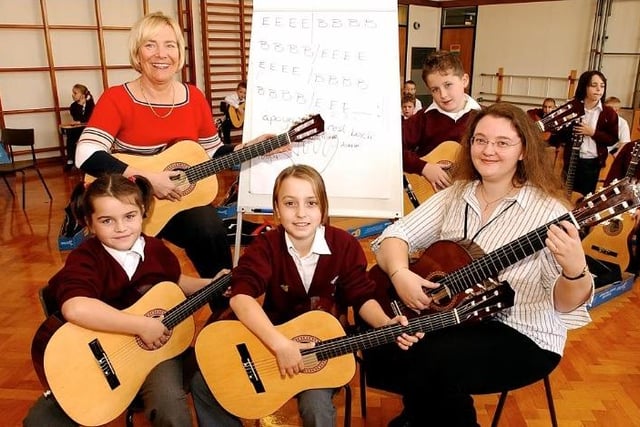 Stockingate Mill School, South Kirkby. Children learning to play the guitar. Children l-r, Katie Sykes, Chloe Bailey, Adam Goodyear. Class teacher, Mrs.Sandra Steadman, and Miss Jayne Anne Webster, teacher in charge of guitar with Wakefield Music Services.