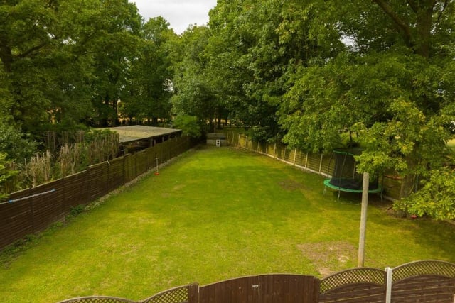 A section of the lawned and tiered gardens within six-plus acres of land with the property.