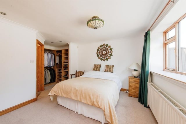 Bedroom one includes a dressing area, fitted wardrobes, spotlights to the ceiling, a gas central heating radiator, a double glazed window to the rear and access into the ensuite.