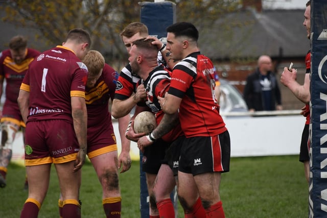 Normanton Knights players celebrate scoring a try.